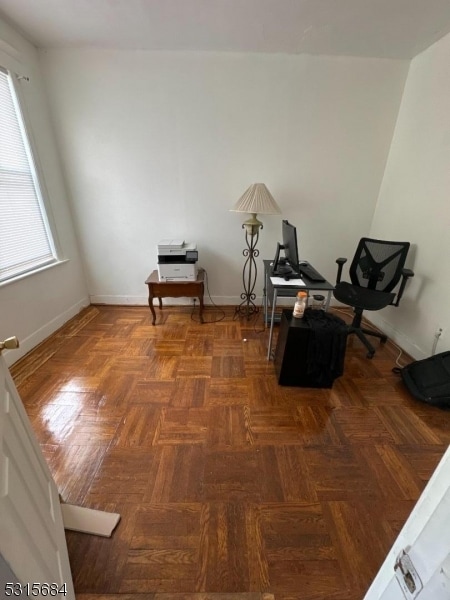 sitting room with dark parquet floors