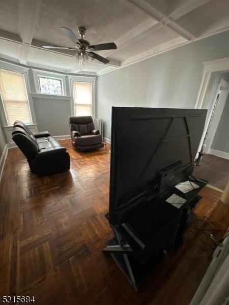 interior space featuring ornamental molding, beamed ceiling, ceiling fan, and coffered ceiling