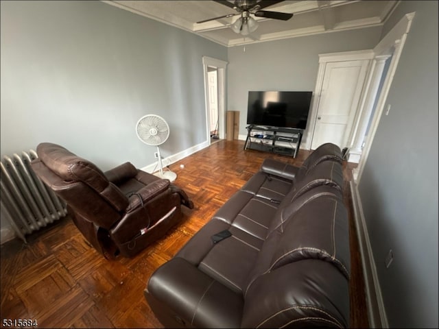 living room featuring ornamental molding, dark parquet floors, and ceiling fan