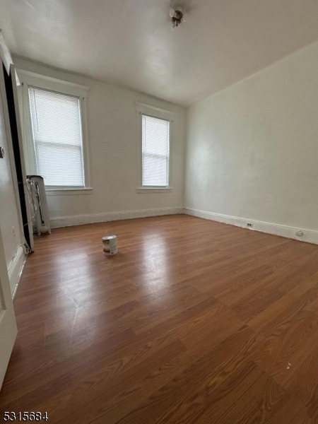 unfurnished room with radiator and hardwood / wood-style flooring