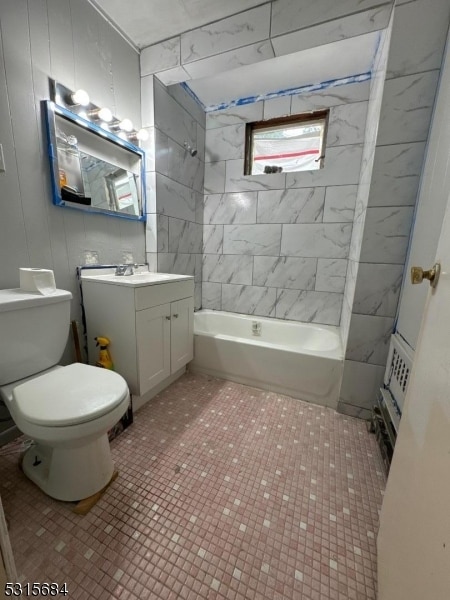 full bathroom with tiled shower / bath, vanity, toilet, and tile patterned floors