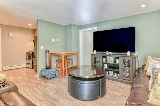 living room featuring baseboard heating and light wood-type flooring