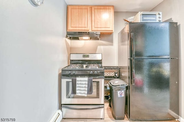 kitchen featuring gas range, light brown cabinetry, and black refrigerator