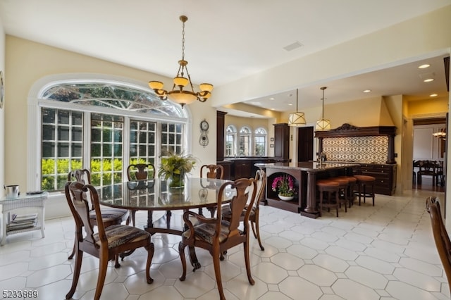 dining area with light tile patterned flooring and a chandelier