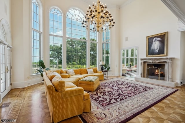 sunroom / solarium with a wealth of natural light, a high end fireplace, and a chandelier