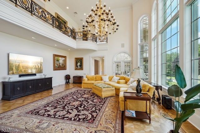 interior space featuring crown molding, a high ceiling, and a notable chandelier