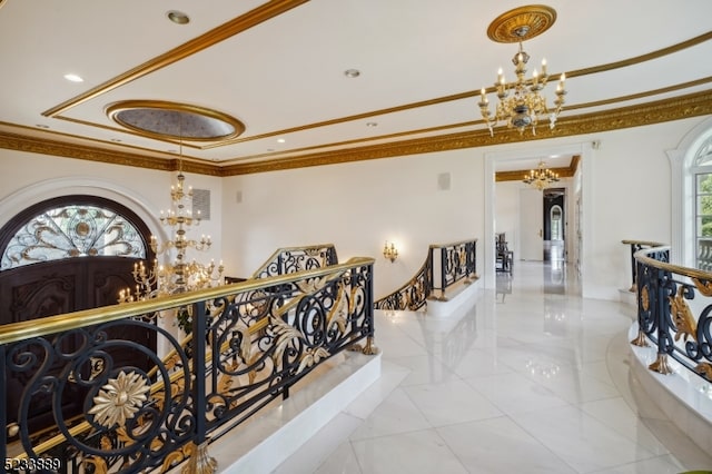 hallway featuring a notable chandelier and ornamental molding