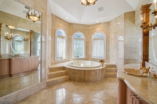 bathroom with tile walls, vanity, and separate shower and tub