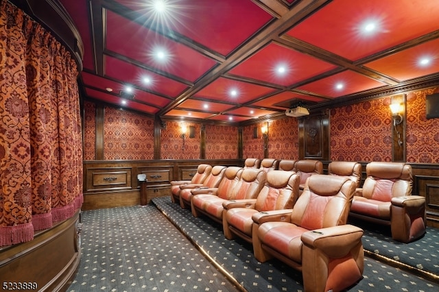 carpeted home theater room with coffered ceiling