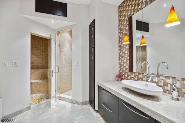 bathroom with decorative backsplash, tile patterned flooring, walk in shower, and vanity