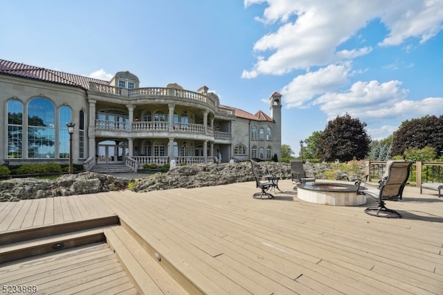 wooden terrace with a fire pit