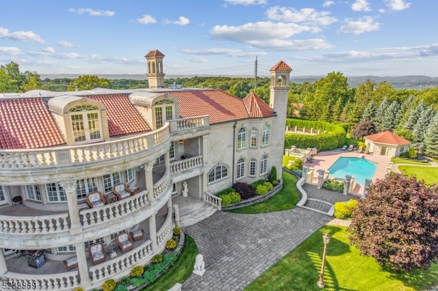 back of property with a balcony and a patio area