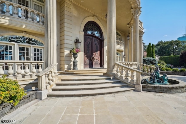 view of exterior entry featuring a balcony