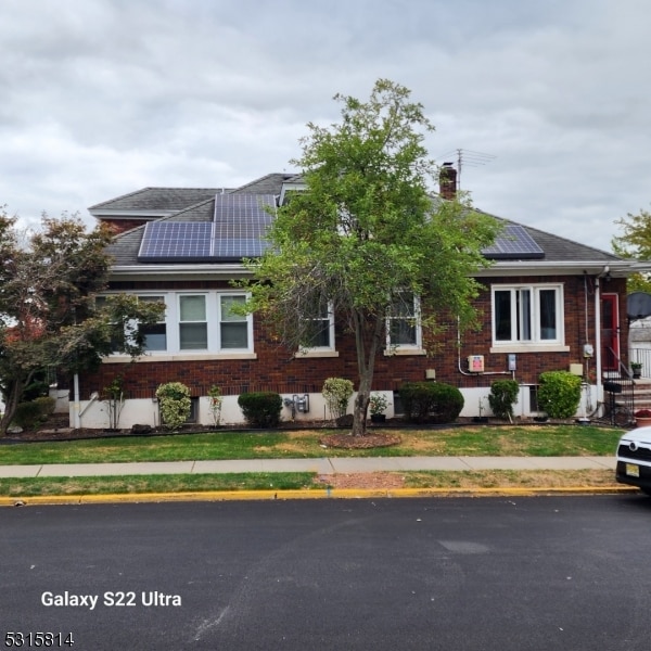 view of front of house featuring solar panels