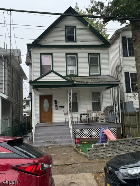 view of front of home with cooling unit and covered porch