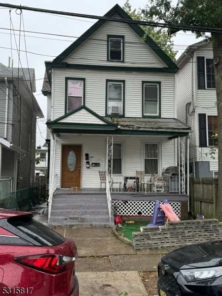 view of front of house with cooling unit and a porch