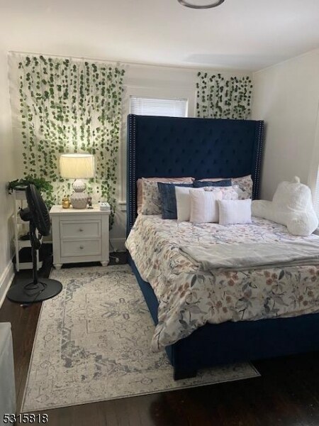 bedroom with wood-type flooring