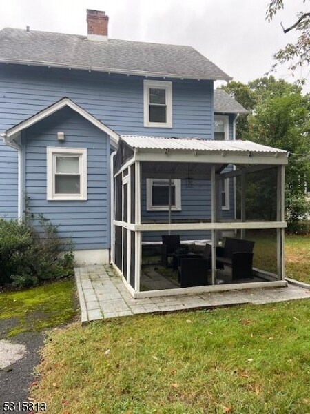 back of property with a patio and a yard