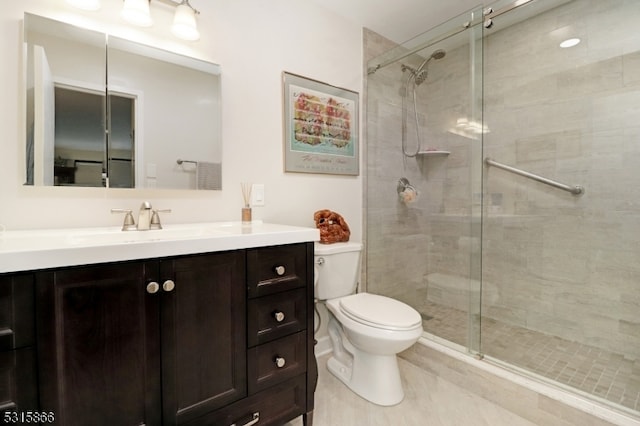 bathroom featuring tile patterned flooring, walk in shower, vanity, and toilet