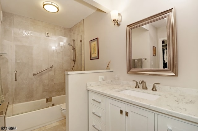 full bathroom featuring bath / shower combo with glass door, toilet, and vanity