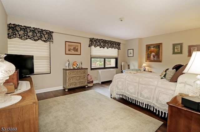 bedroom with dark wood-type flooring