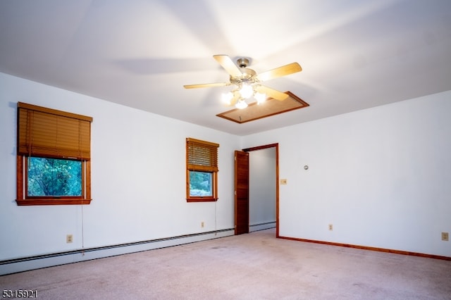 spare room with a baseboard heating unit, ceiling fan, and carpet flooring