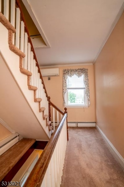 stairs with crown molding, carpet flooring, an AC wall unit, and a baseboard radiator