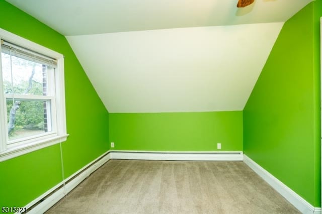 bonus room with ceiling fan, light colored carpet, a baseboard radiator, and lofted ceiling