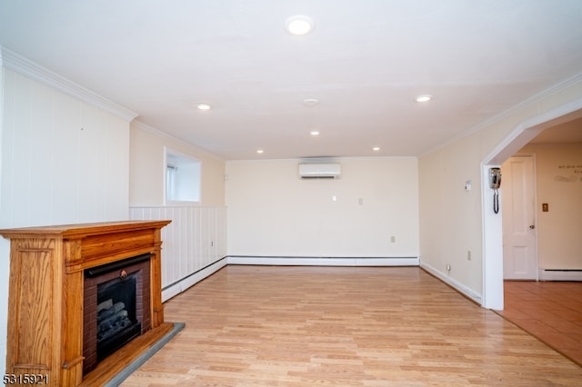 unfurnished living room with light wood-type flooring, crown molding, baseboard heating, and an AC wall unit