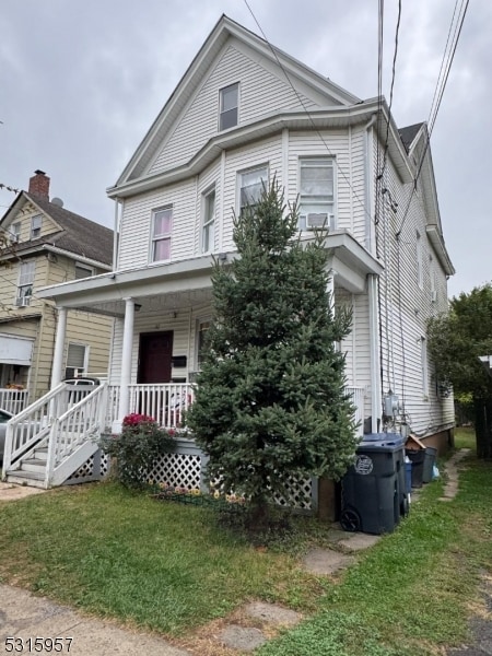 view of front of house with a porch and a front lawn