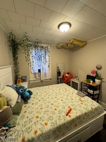 bedroom featuring ornamental molding and cooling unit