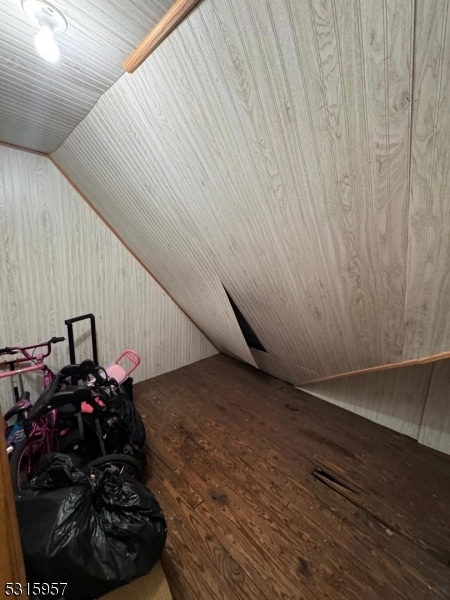 bonus room featuring vaulted ceiling and hardwood / wood-style flooring