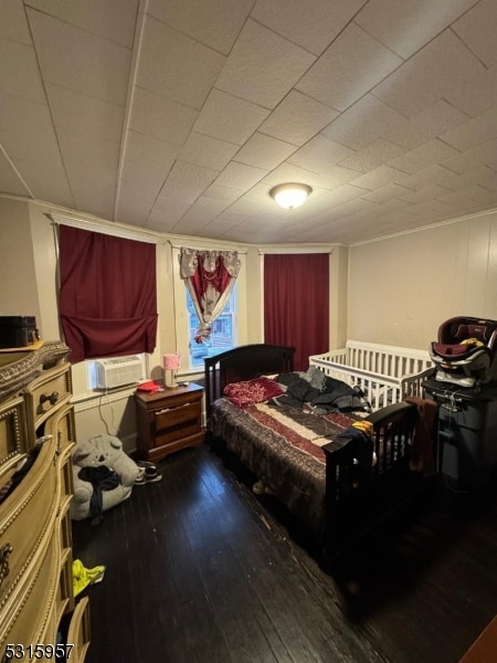 bedroom featuring cooling unit and hardwood / wood-style flooring