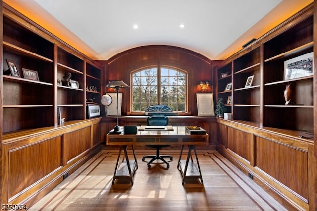 home office featuring wood-type flooring and built in features