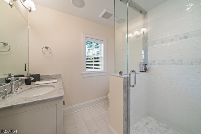 bathroom featuring a shower with door, toilet, vanity, and tile patterned floors