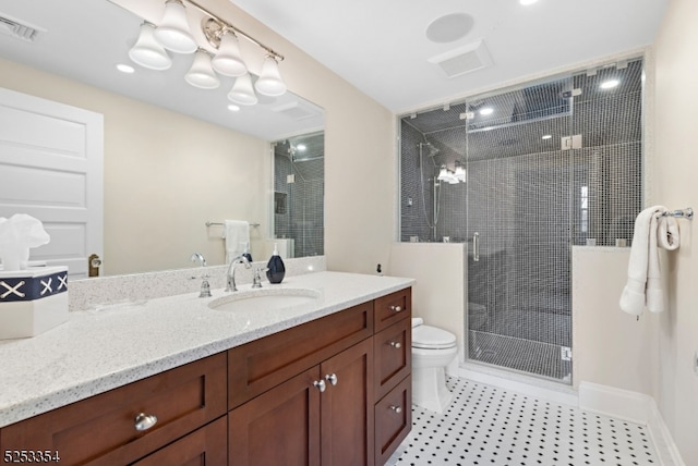 bathroom with vanity, toilet, and an enclosed shower