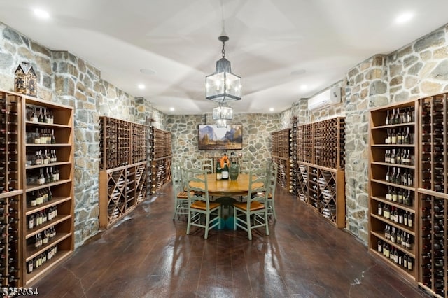 wine room featuring hardwood / wood-style flooring and an AC wall unit