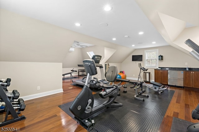 workout area with lofted ceiling and dark wood-type flooring