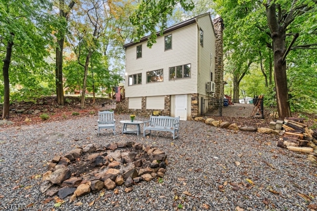 back of house featuring a fire pit