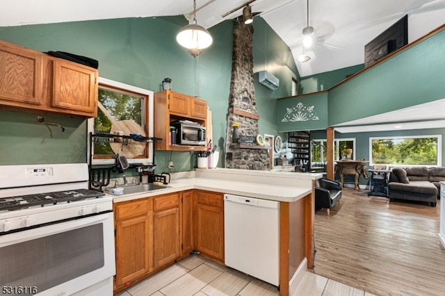 kitchen featuring ceiling fan, hanging light fixtures, white appliances, high vaulted ceiling, and light wood-type flooring