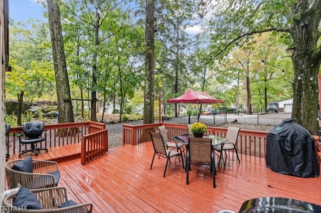 wooden terrace featuring a grill