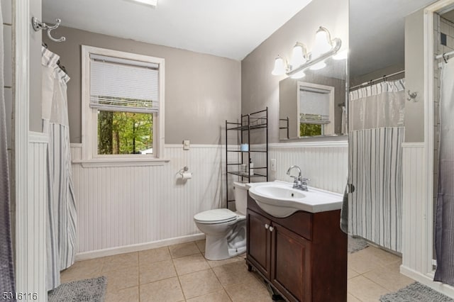 bathroom with tile patterned flooring, vanity, and toilet