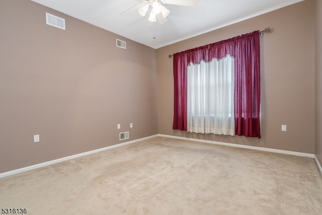 carpeted spare room featuring ceiling fan