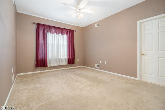 empty room featuring carpet and ceiling fan