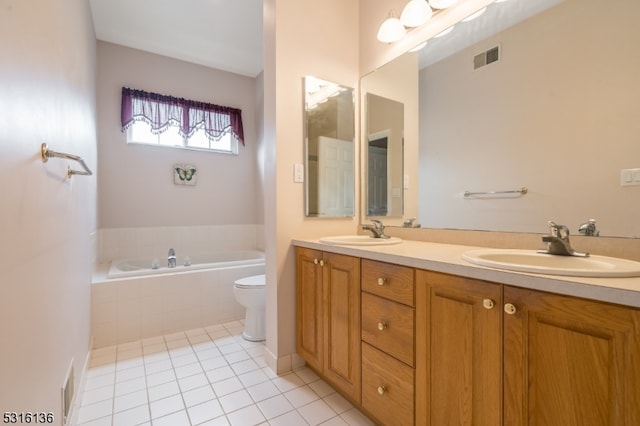 bathroom with vanity, tile patterned flooring, a relaxing tiled tub, and toilet