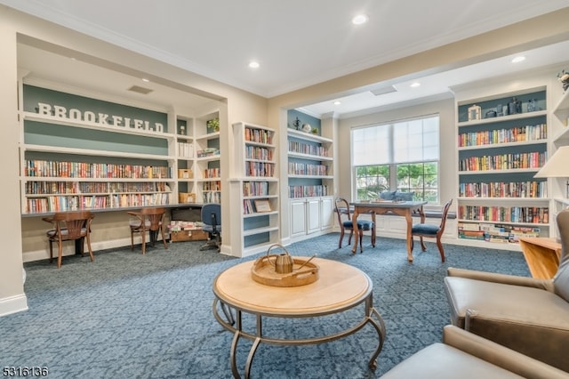 living area with built in shelves, crown molding, and carpet flooring