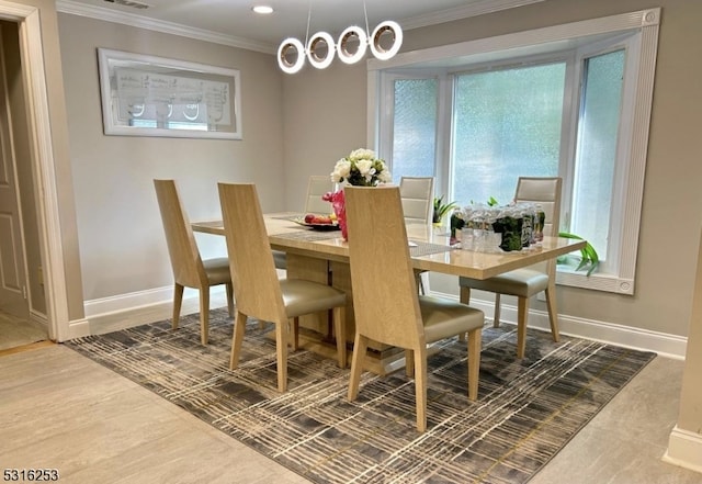 dining area featuring plenty of natural light and ornamental molding