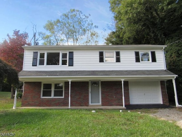 view of front of house with a front yard and a garage