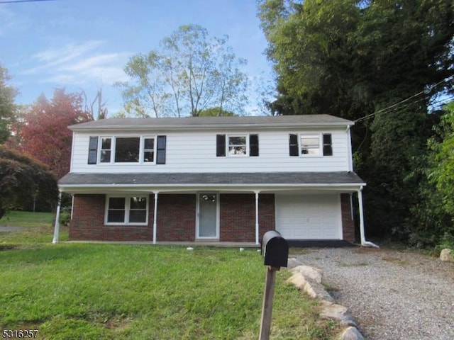 view of property with a front yard and a garage