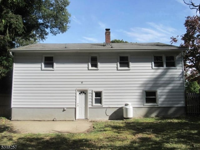 back of house with a lawn